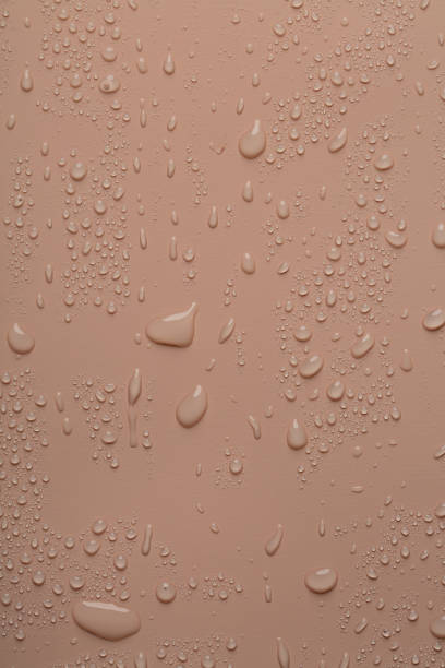 istock Water drops on coral  color  surface 2167559846