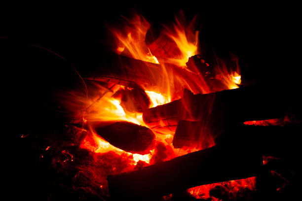 Hot flame of burning wood in darkness
