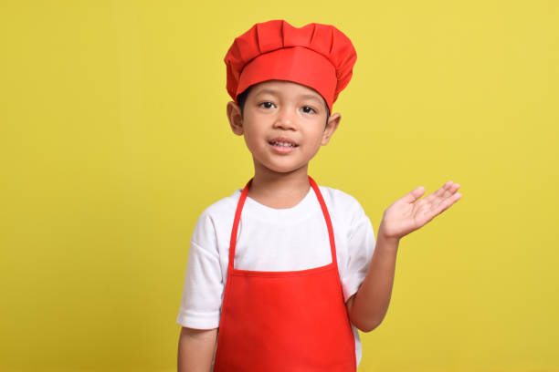 istock Cute little chef showing Blank Space Next to with pointing hand gesture 2167563839