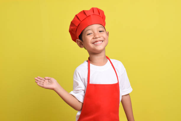 istock Cute little chef showing Blank Space Next to with pointing hand gesture 2167564045