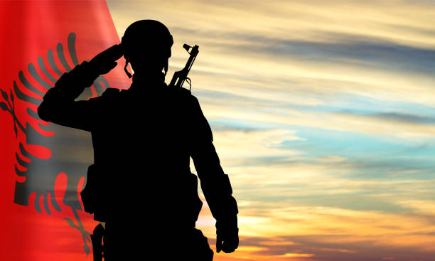 istock Silhouette of a saluting soldier with Albania flag 2167564971
