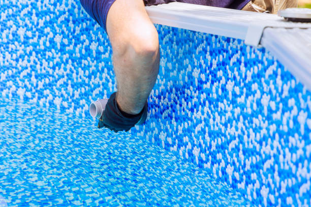 istock Water filtration, chlorination are installed by maintenance service worker in a frame pool 2167565764