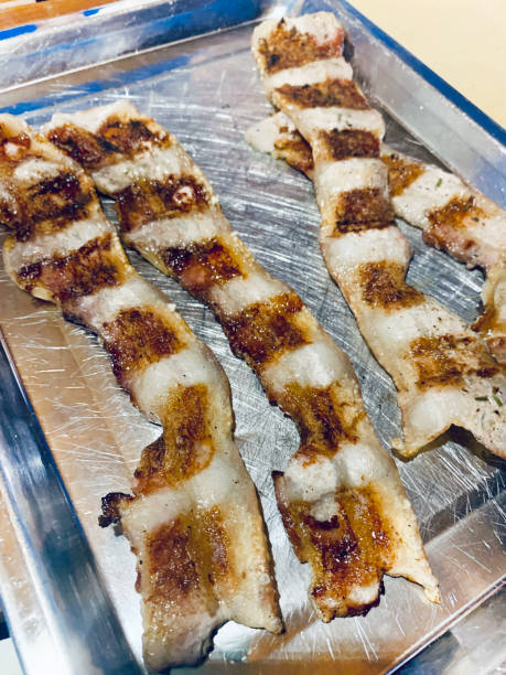 istock Thin slices of bacon fried on the grill. 2167565774