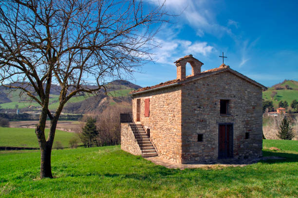 istock bare tree next to a small country church 2167565783