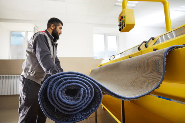 istock Man operating carpet automatic cleaning machine in professional laundry service 2167567074