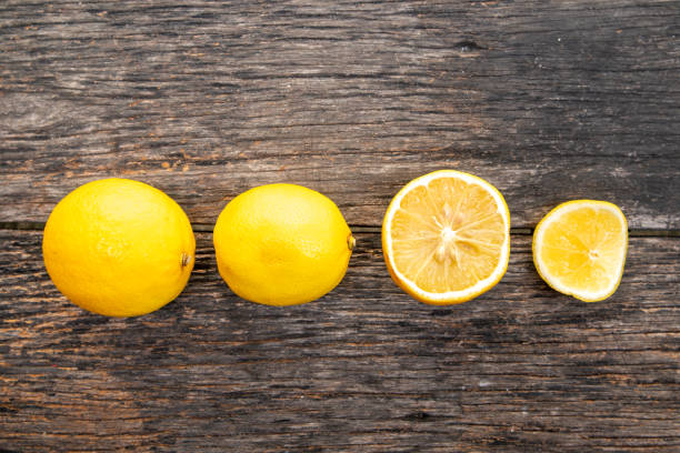 Fresh yellow lemons, healthy fruit on brown wooden table with copy space.