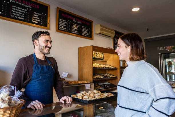 istock Retail clerk and customer talking at bakery 2167569888