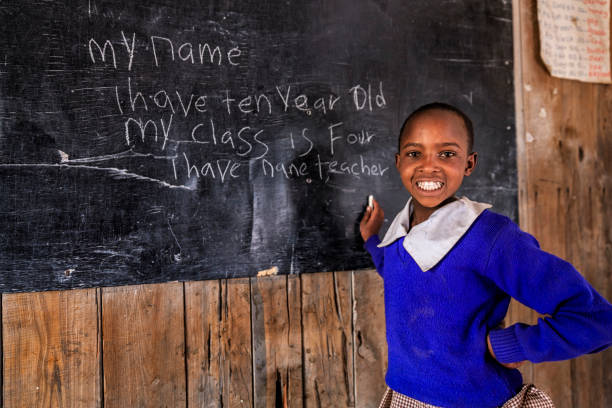 istock African young girl is learning English language, Kenya 2167570434