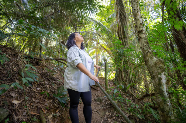 istock Beautiful woman descending difficult trail in the Amazon rainforest. 2167570645