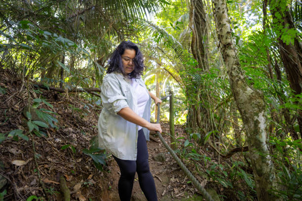 istock Beautiful woman descending difficult trail in the Amazon rainforest. 2167570646