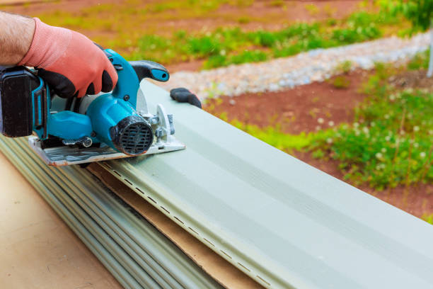 istock Worker cut plastic vinyl siding to a required size with circular handsaws before installing it 2167571316