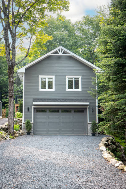 Luxurious gray and white two-story detached double garage located in Quebec, Canada during summer.