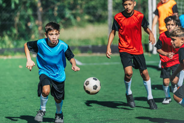 istock boys fighting for soccer ball in match 2167573838