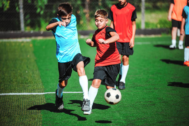 istock two boys fighting for soccer ball in match 2167573876
