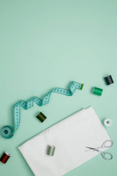 istock Composition with various threads and sewing accessories on green background. Top view, copy space 2167574034