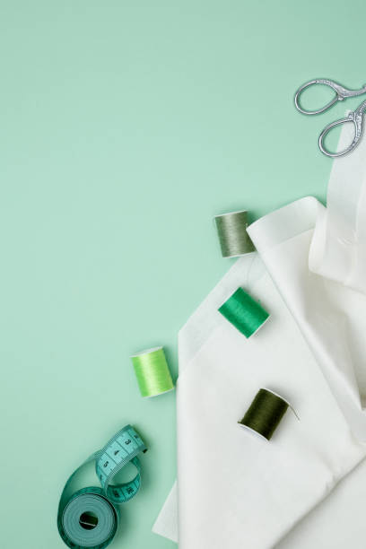 istock Composition with various threads and sewing accessories on green background. Top view, copy space 2167574047