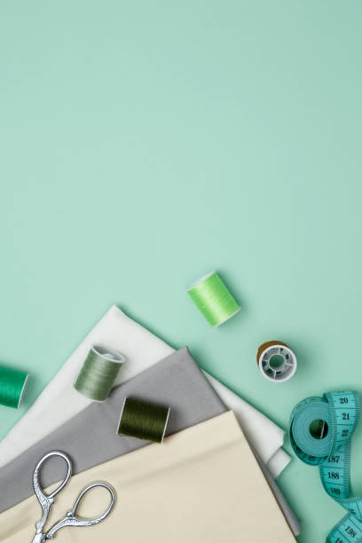 istock Composition with various threads and sewing accessories on green background. Top view, copy space 2167574060