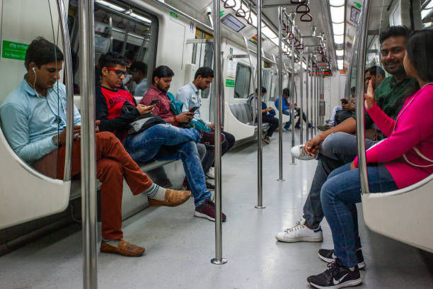 New Delhi, India - 19 November 2022: Passengers inside the Delhi Metro is a mass rapid transit (MRT) system serving Delhi and its satellite cities of Ghaziabad, Faridabad,