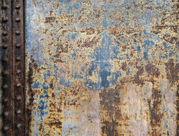 istock Multi-colored urban rusty steel wall with rivets background 2167578828