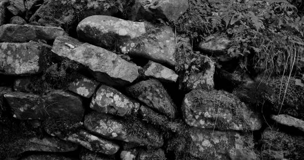 istock Black stones darkened with time and placed in old masonry monochrome stock image 2167578990