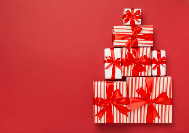 istock Gift boxes in Christmas tree shape on color background, top view 2167580466