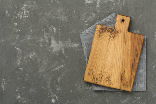 istock Cutting board with napkin on concrete background, top view 2167581256
