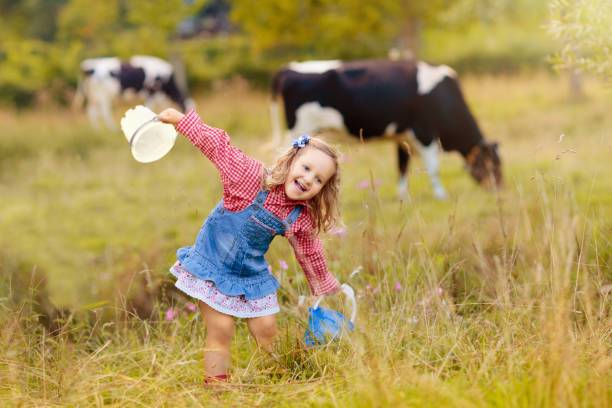 istock Kids watch cow on dairy farm 2167581849