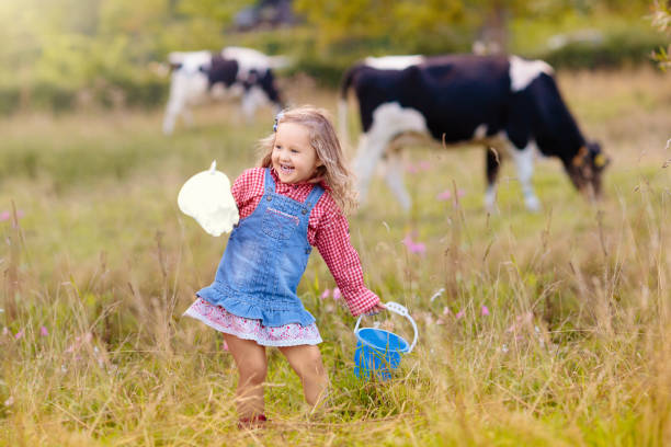 istock Kids watch cow on dairy farm 2167582062