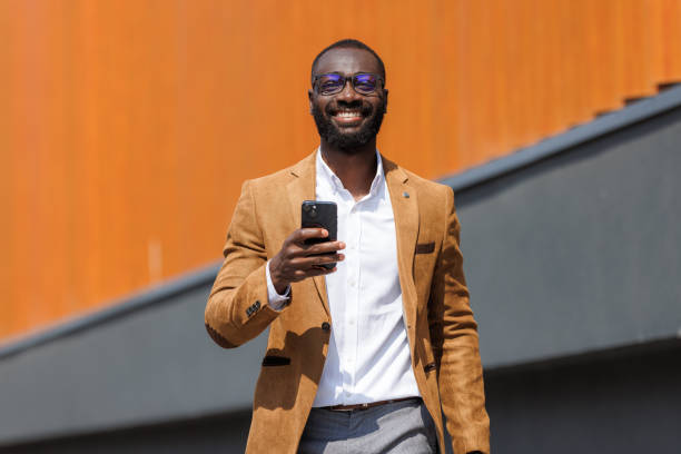 istock Confident businessman using smart phone outdoors 2167583830