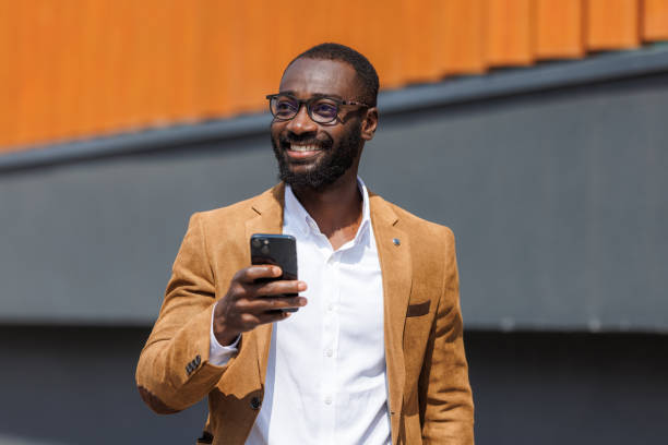 istock Confident businessman using smart phone outdoors 2167583845