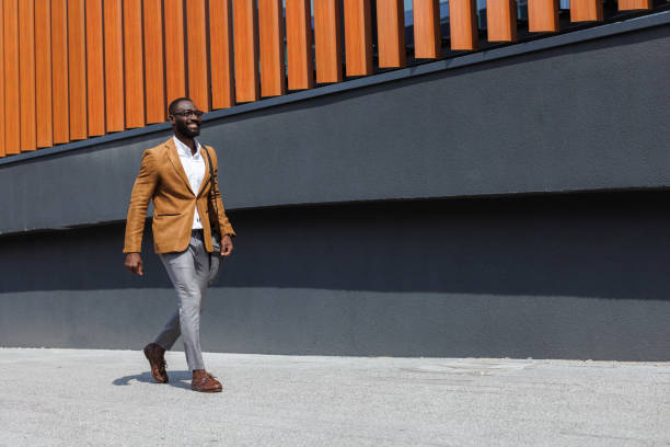 Confident businessman walking outside the modern office building
