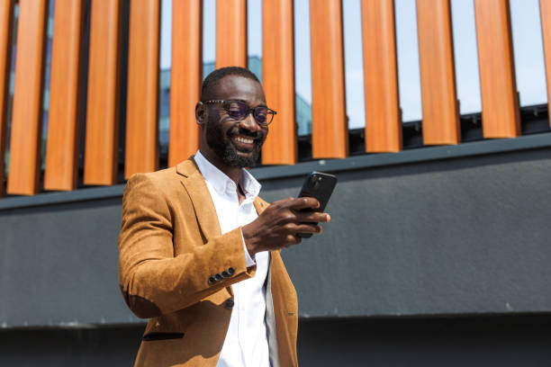 istock Stylish businessman using smart phone outdoors 2167583885