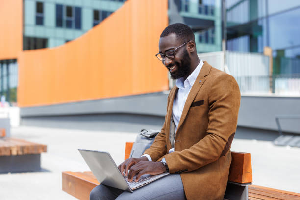 istock African American businessman using laptop outside 2167583909