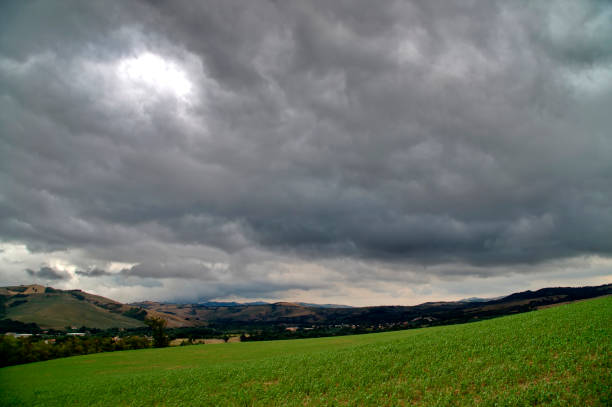 istock Green field under a stormy sky 2167585684