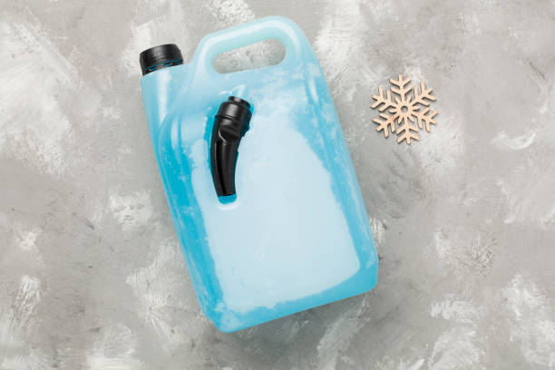 Can with antifreeze on concrete background, top view
