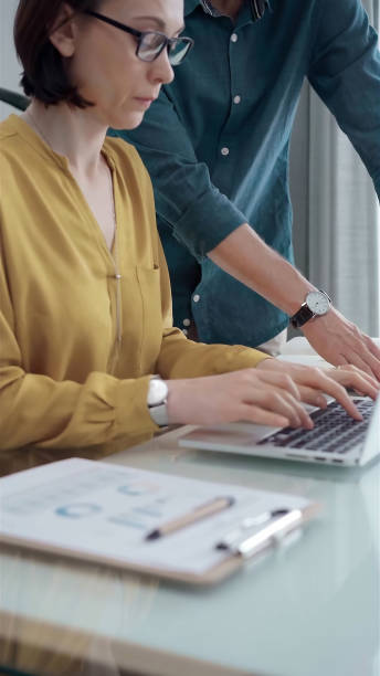 istock Business professionals analyzing financial reports. Casual dressed business people discussing financial data and reports in office 2167586488