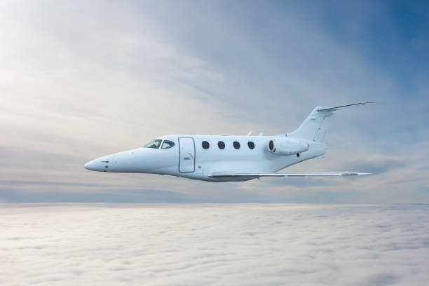 istock White executive airplane flying in the air above the clouds 2167586649