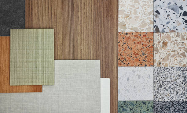 istock close up image of interior material samples, top view, including multi color of terrazzo stones, oak wooden laminated, wooden veneer, fabric laminateds placed on black concrete table. 2167587412