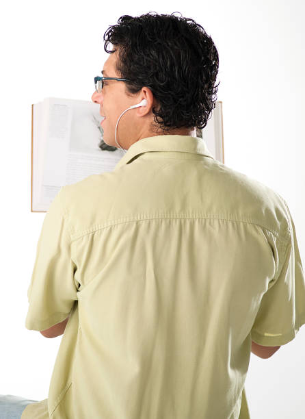 Happy Young Man with a Book Laughing on the White Background