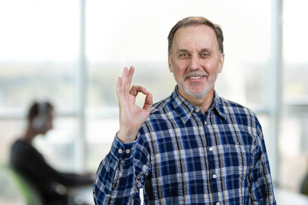istock Smiling confident mature man giving an okay gesture. 2167588439