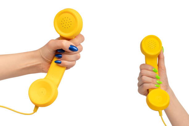 istock Yellow handset in woman hand isolated on white. Copy space. 2167589157