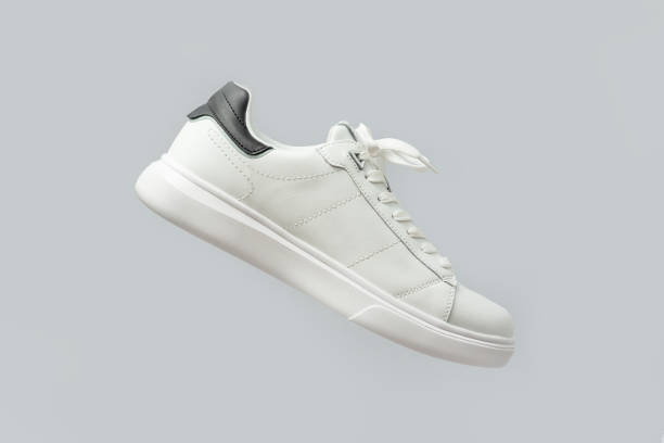 istock White leather sneakers on gray background 2167590893