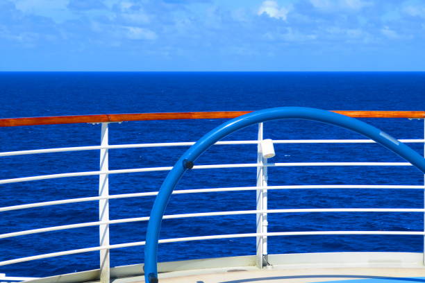 A view of the sun shining down on the Caribbean Sea from a cruise ship deck