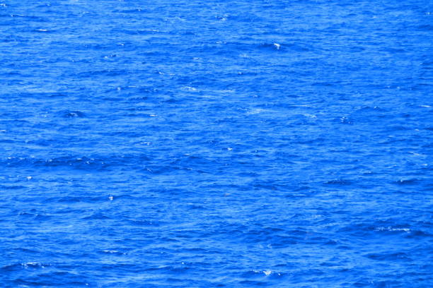 A view of the sun shining down on the Caribbean Sea from a cruise ship deck