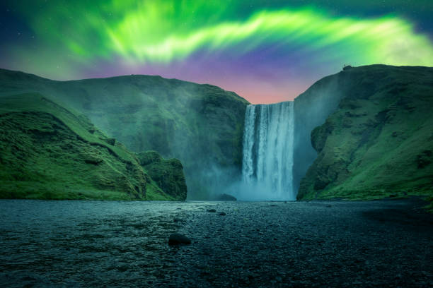 istock Green aurora light behind famous Skogafoss waterfall 2167596166