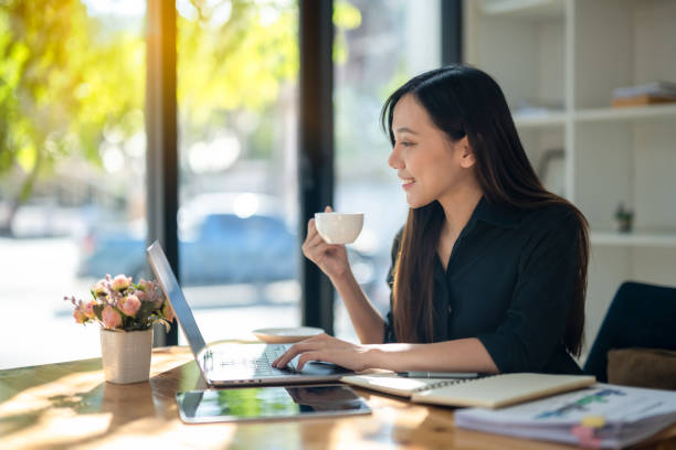 istock Asian woman enjoying morning coffee during break from work 2167597087
