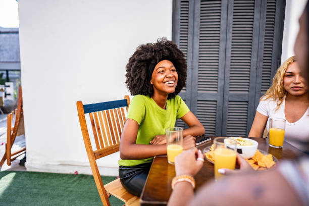 istock Young woman talking while eating with friends at a hostel 2167604772