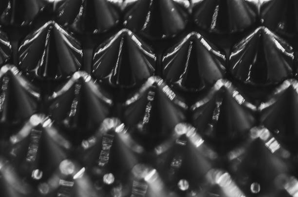 istock Close-up macro of sewing studs arranged in symmetrical rows in black and white abstraction abstract 2167605176
