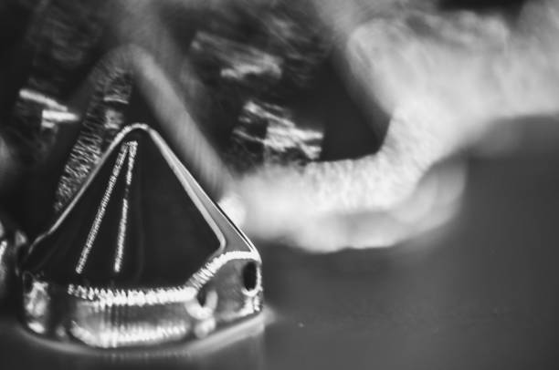 Monochrome image of skull and light saber on black background with copy space