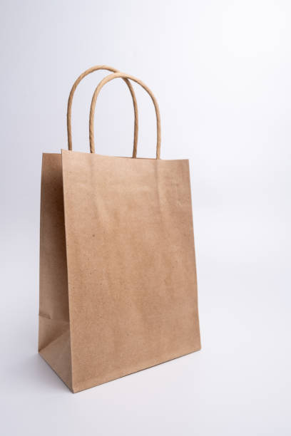 istock Kraft paper bag on a light background. Delivery and shopping concept. Packaging template mockup 2167606071